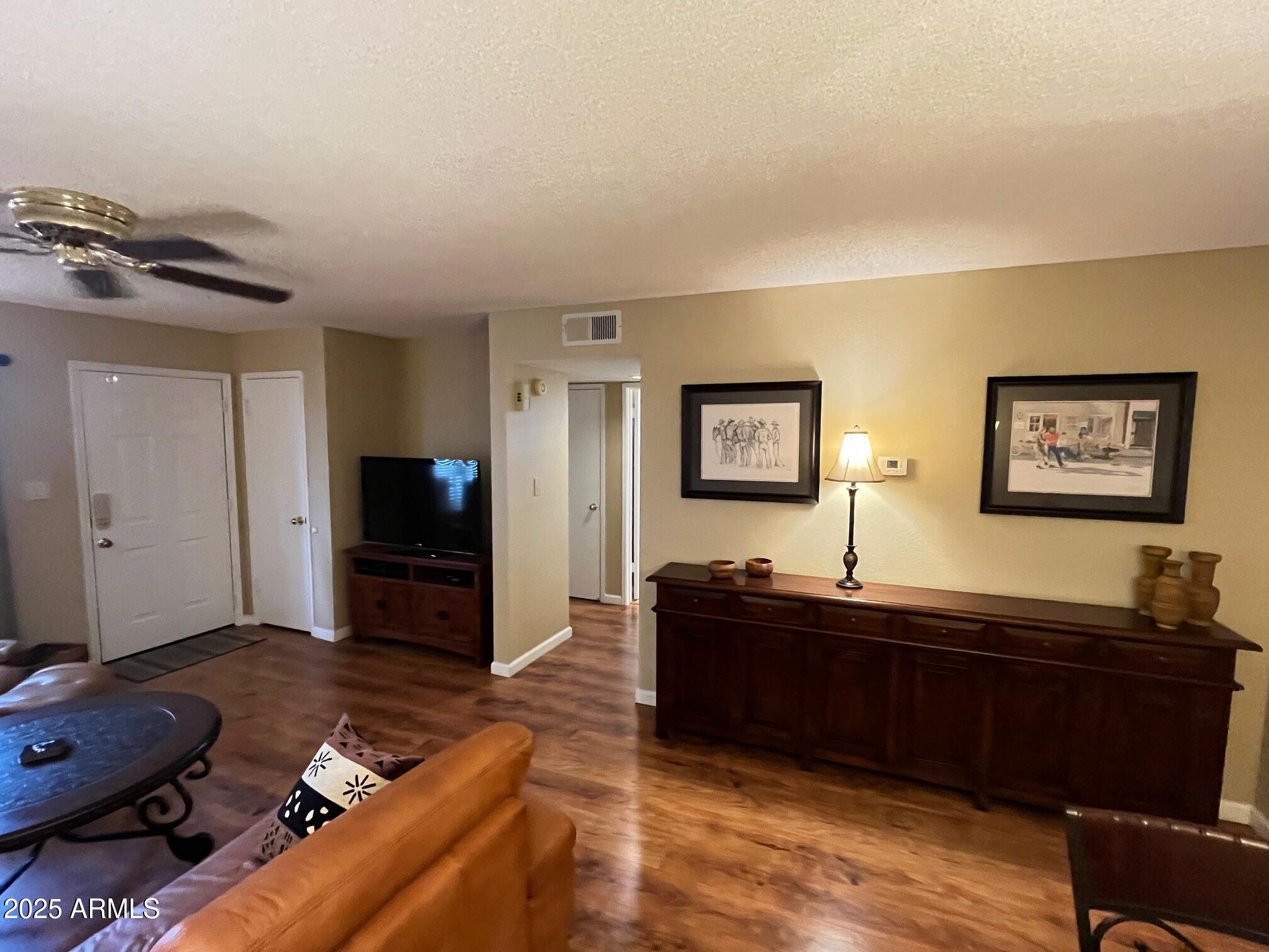 5518 East Lindstrom Lane, Unit 2020 Mesa, AZ 85215 - Photo 28 of 35 a living room with furniture and a flat screen tv