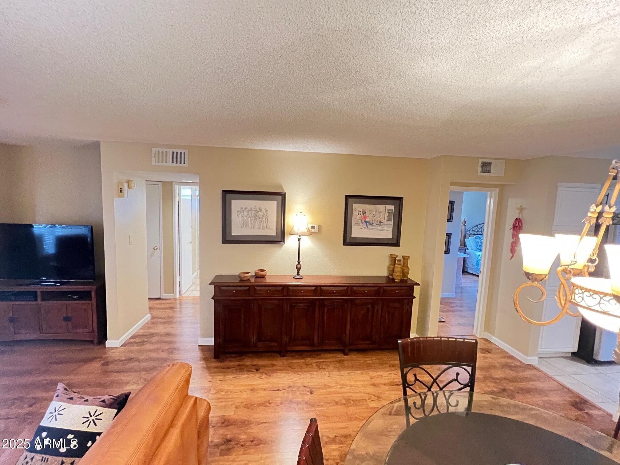 5518 East Lindstrom Lane, Unit 2020 Mesa, AZ 85215 - Photo 29 of 35 a living room with furniture and a flat screen tv