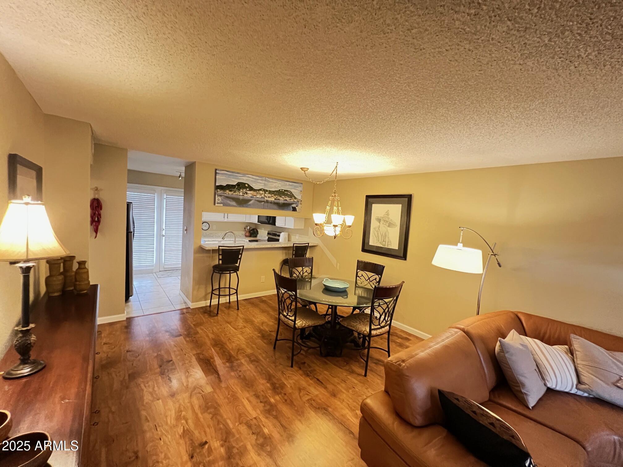 5518 East Lindstrom Lane, Unit 2020 Mesa, AZ 85215 - Photo 31 of 35 a living room with furniture and a wooden floor