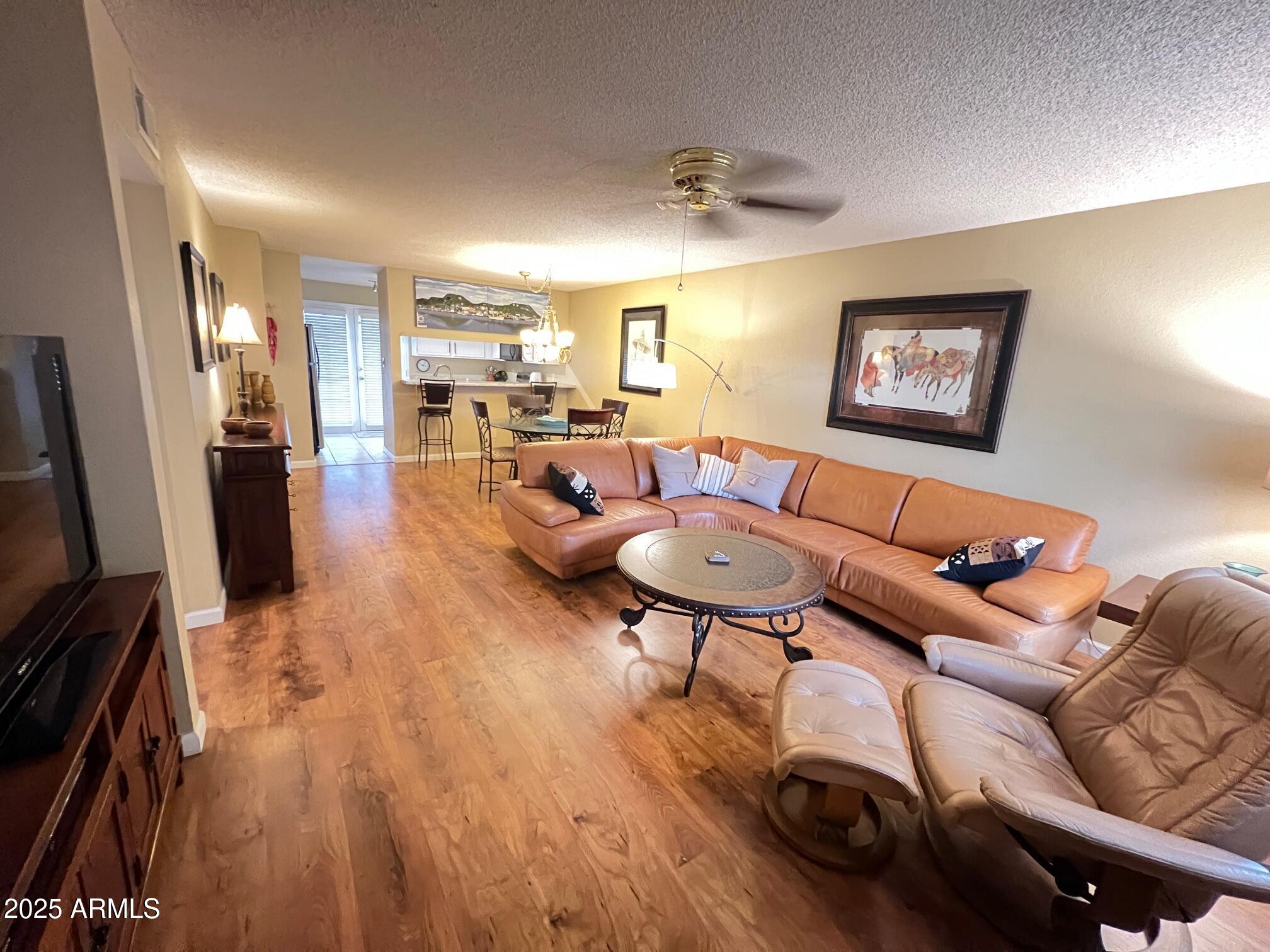 5518 East Lindstrom Lane, Unit 2020 Mesa, AZ 85215 - Photo 34 of 35 a living room with furniture and a flat screen tv
