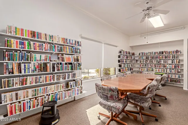 a view of a dining room with furniture and a book shelf