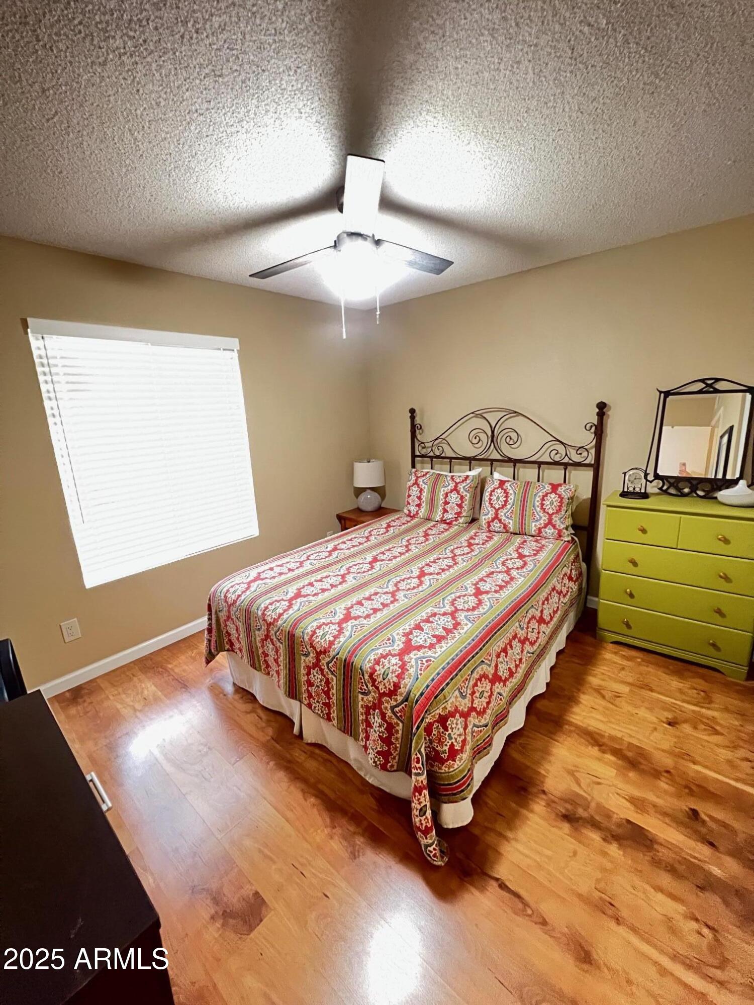 5518 East Lindstrom Lane, Unit 2020 Mesa, AZ 85215 - Photo 10 of 35 a bedroom with a bed and window