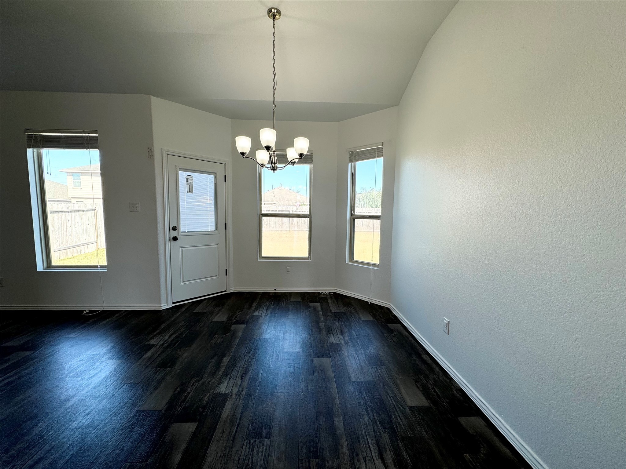 20626 Rimini River Way Katy, TX 77449 - Photo 9 of 21 a view of an empty room with wooden floor and a window