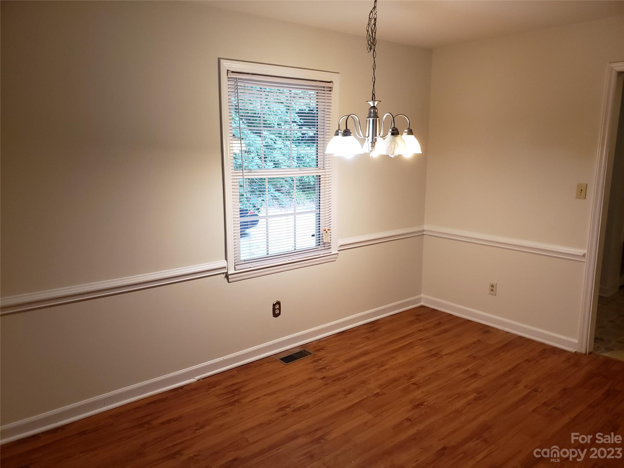 800 Silverleaf Road Charlotte, NC 28217 - Photo 4 of 6 a room with wooden floor and windows