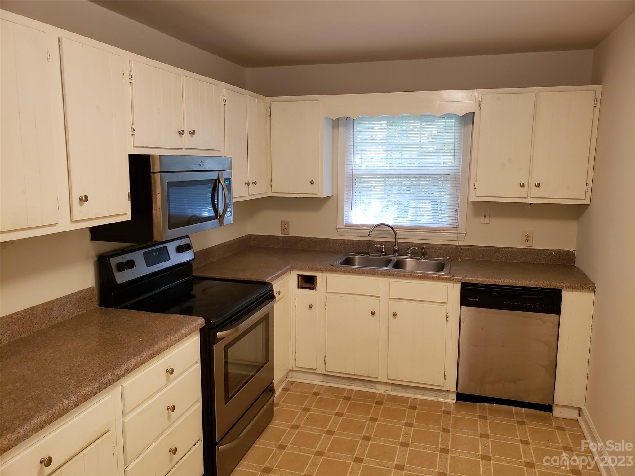 800 Silverleaf Road Charlotte, NC 28217 - Photo 5 of 6 a kitchen with granite countertop white cabinets white stainless steel appliances a sink and a window