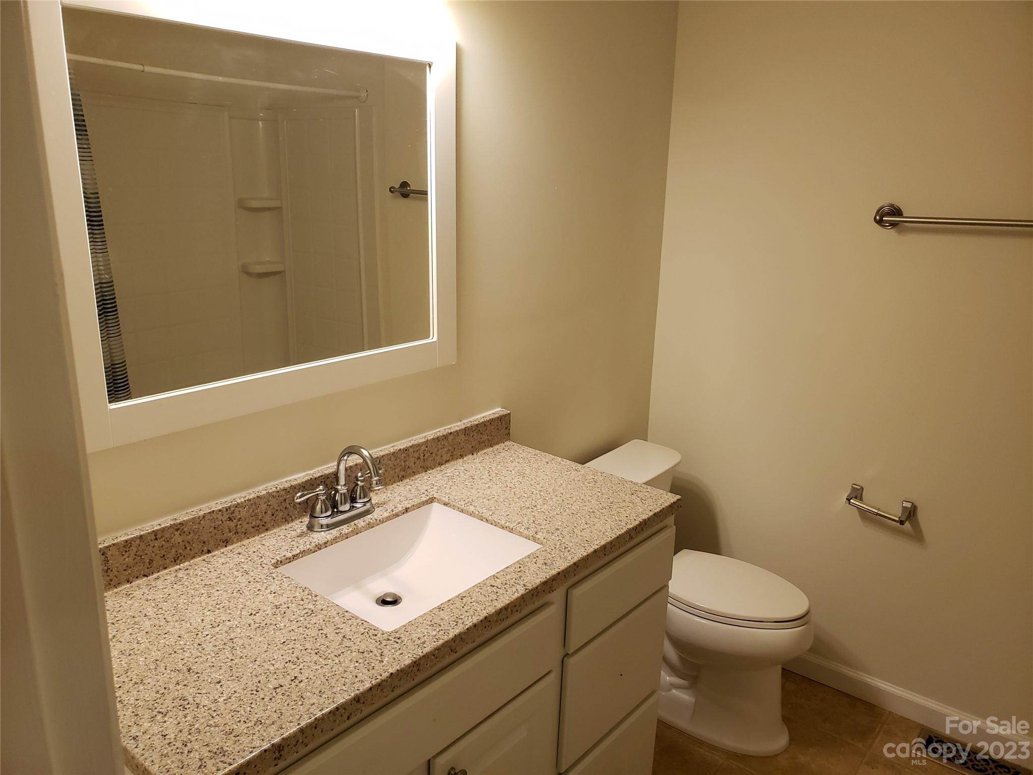 800 Silverleaf Road Charlotte, NC 28217 - Photo 6 of 6 a bathroom with a granite countertop sink toilet and mirror
