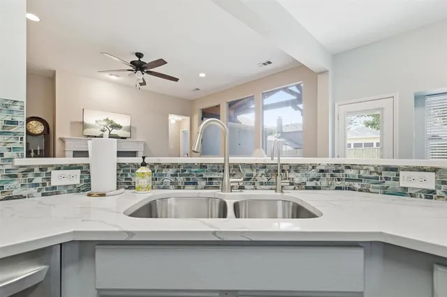 a kitchen with a sink and a refrigerator