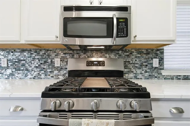 a stove top oven sitting inside of a kitchen