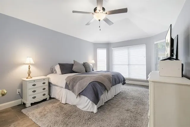 a bedroom with bed and window