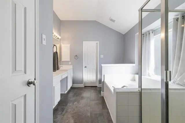 a bathroom with a tub and shower