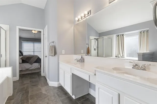 a en suite bathroom with a sink double vanity