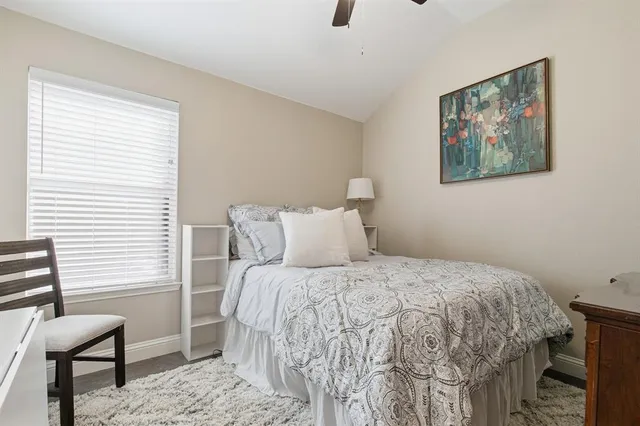 a bedroom with a bed and a chair