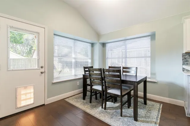 a kitchen with a table chairs sink and cabinets