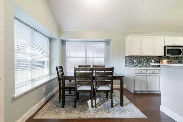 a living room with kitchen island furniture and a wooden floor