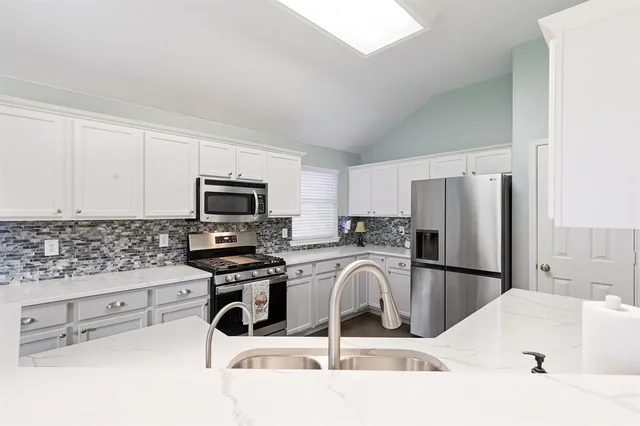a kitchen with a sink a microwave and refrigerator