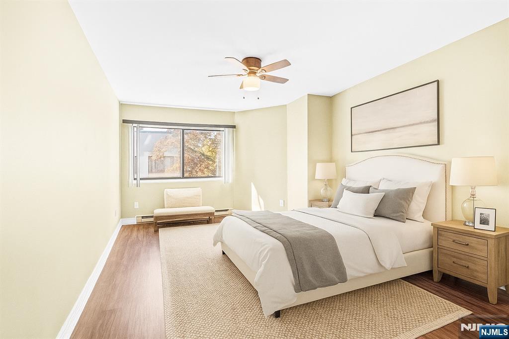 10 Orchard Street, Unit 3E Hackensack, NJ 07601 - Photo 14 of 23 a bedroom with a bed and a chandelier