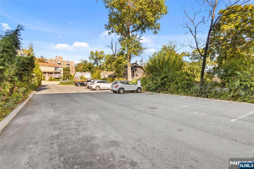 10 Orchard Street, Unit 3E Hackensack, NJ 07601 - Photo 22 of 23 a view of a street with a cars parked on the road
