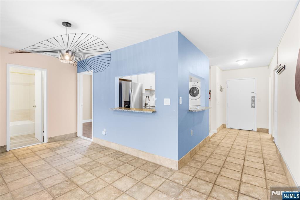 10 Orchard Street, Unit 3E Hackensack, NJ 07601 - Photo 4 of 23 a view of a hallway with a chandelier