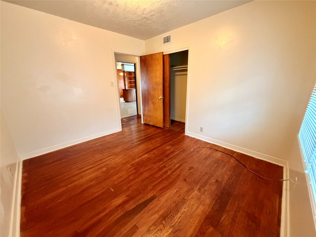 6211 Schevers Street Houston, TX 77087 - Photo 11 of 28 a view of an empty room with closet and wooden floor