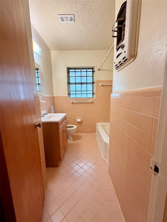 6211 Schevers Street Houston, TX 77087 - Photo 12 of 28 a bathroom with a sink a toilet and shower curtain