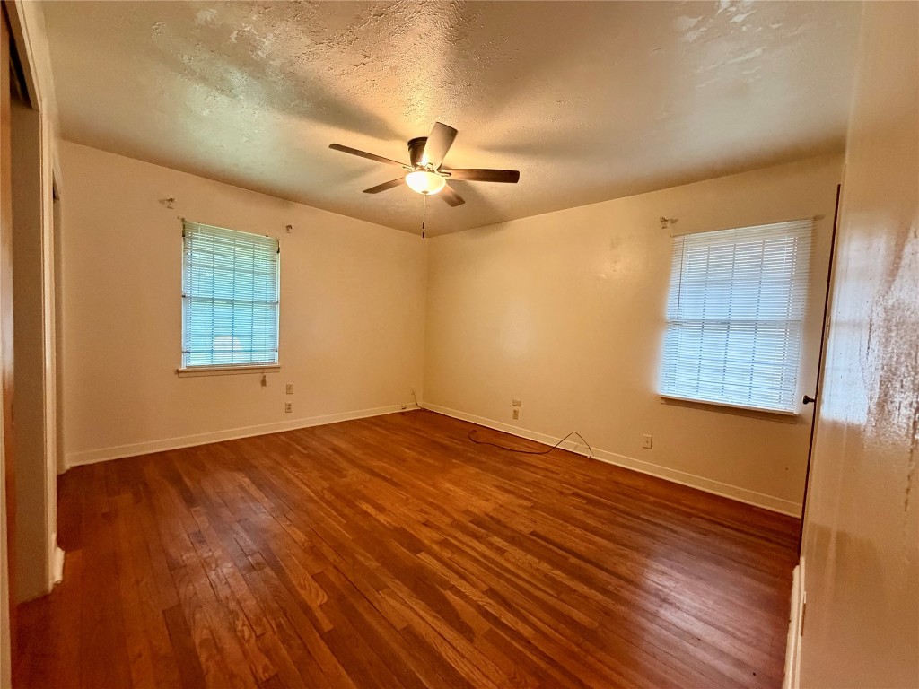6211 Schevers Street Houston, TX 77087 - Photo 14 of 28 a view of an empty room with a window and wooden floor