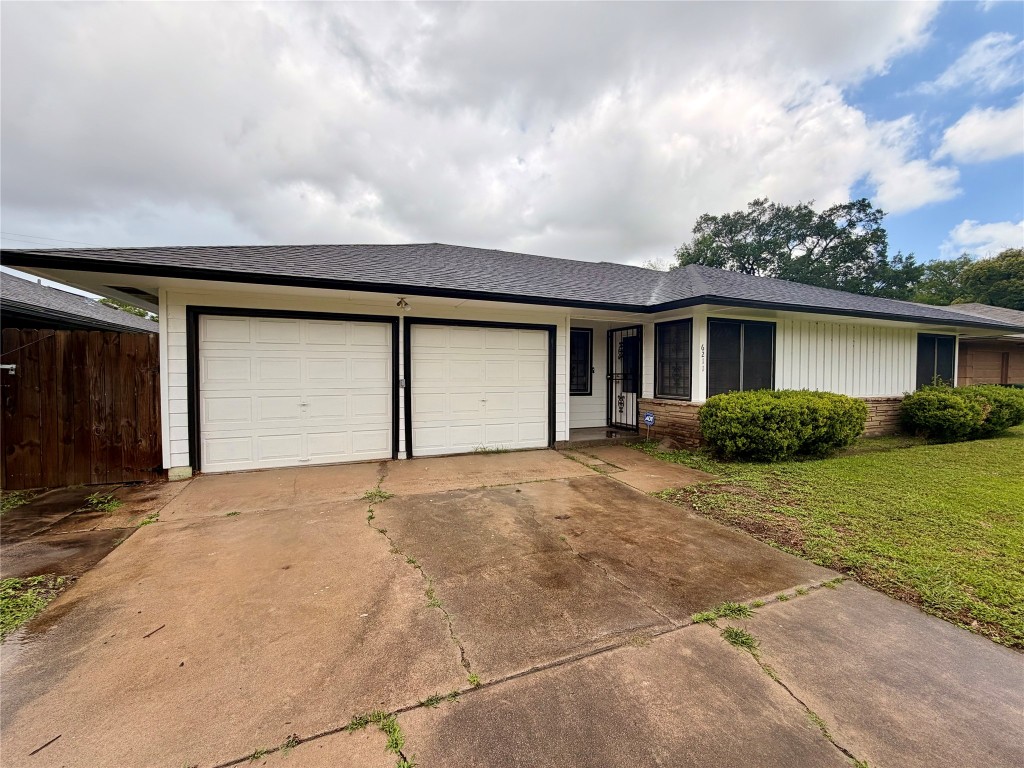 6211 Schevers Street Houston, TX 77087 - Photo 2 of 28 a front view of a house with a yard and garage