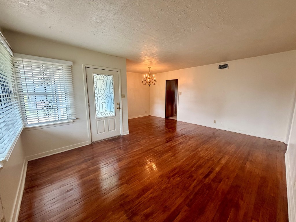 6211 Schevers Street Houston, TX 77087 - Photo 6 of 28 a view of an empty room with wooden floor and a window