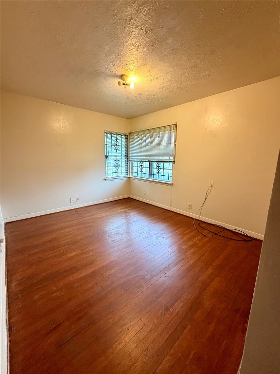 6211 Schevers Street Houston, TX 77087 - Photo 8 of 28 an empty room with wooden floor and windows