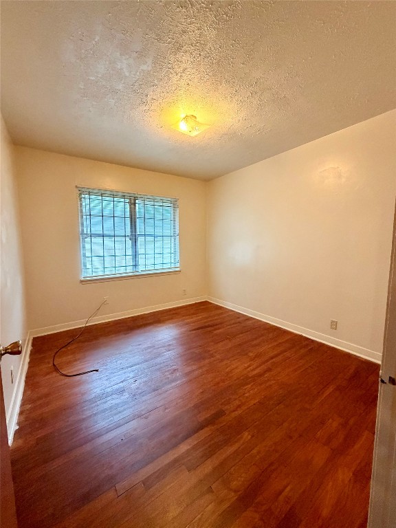 6211 Schevers Street Houston, TX 77087 - Photo 10 of 28 an empty room with wooden floor and windows