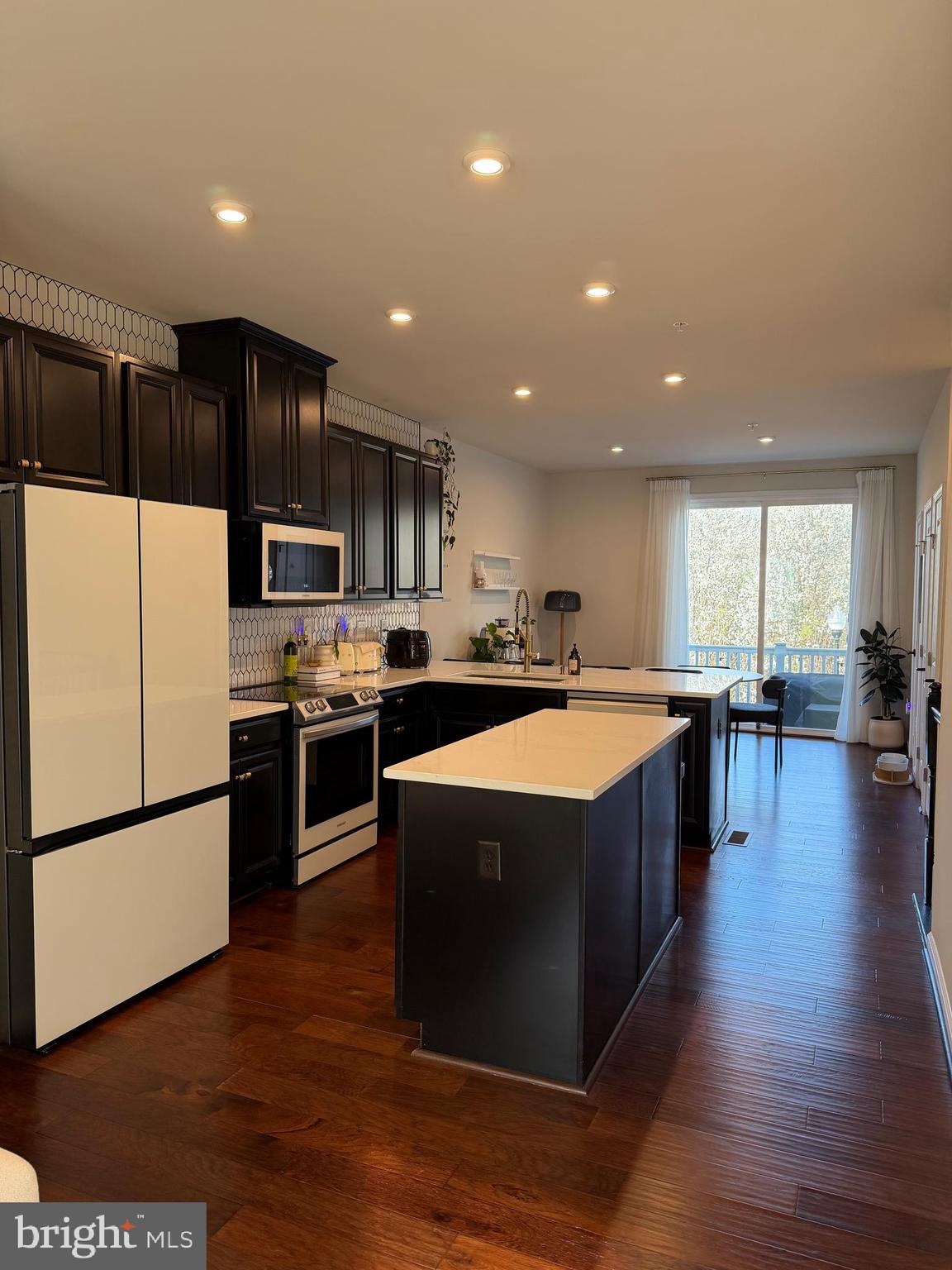 1331 Bruley Road Hanover, MD 21076 - Photo 17 of 18 a kitchen with kitchen island granite countertop a sink a counter top space and stainless steel appliances