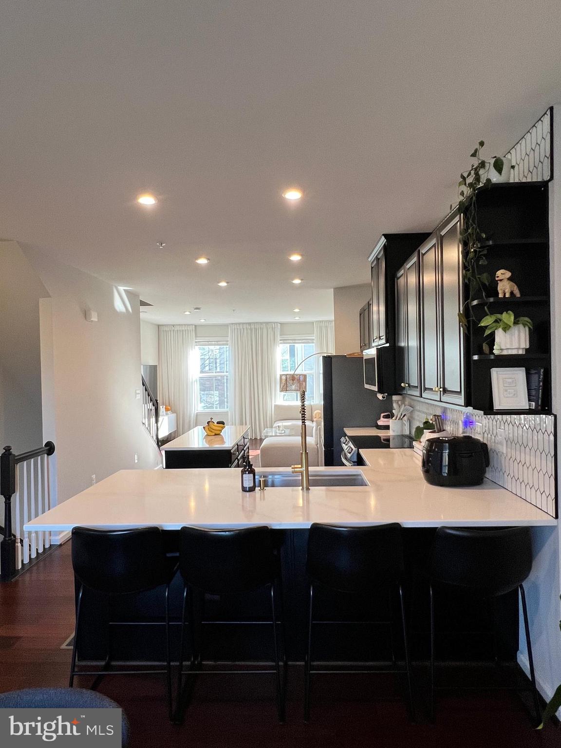 1331 Bruley Road Hanover, MD 21076 - Photo 8 of 18 a kitchen with a sink and chairs