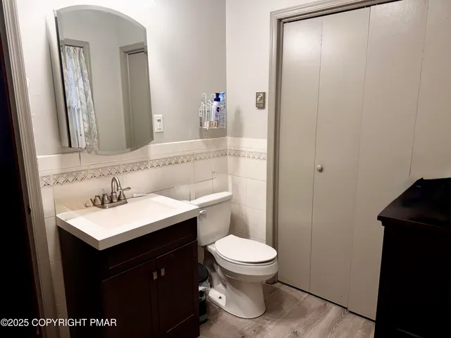 a bathroom with a sink a toilet and mirror