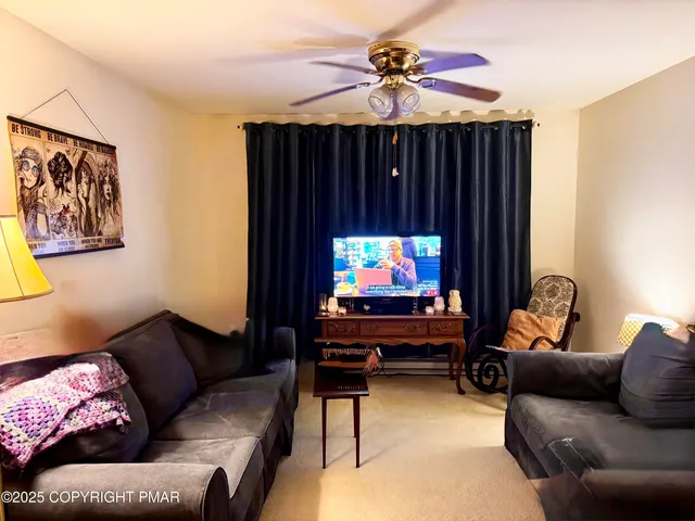 a living room with furniture and a flat screen tv