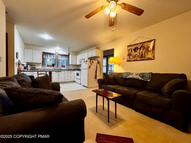 a living room with a couch and a chandelier