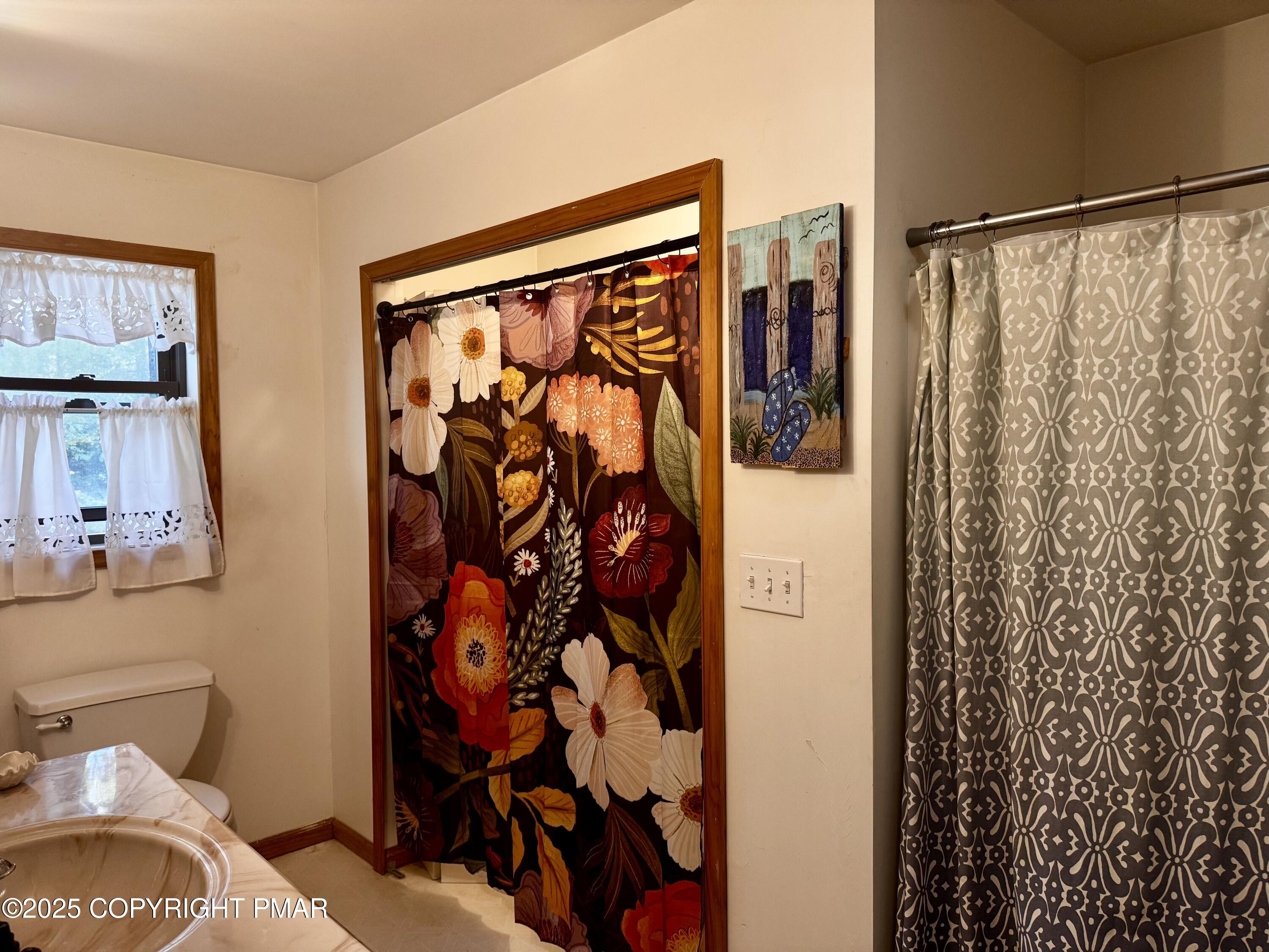 102 Indian Trail Road Jim Thorpe, PA 18229 - Photo 18 of 28 a bathroom with a shower curtain and a sink