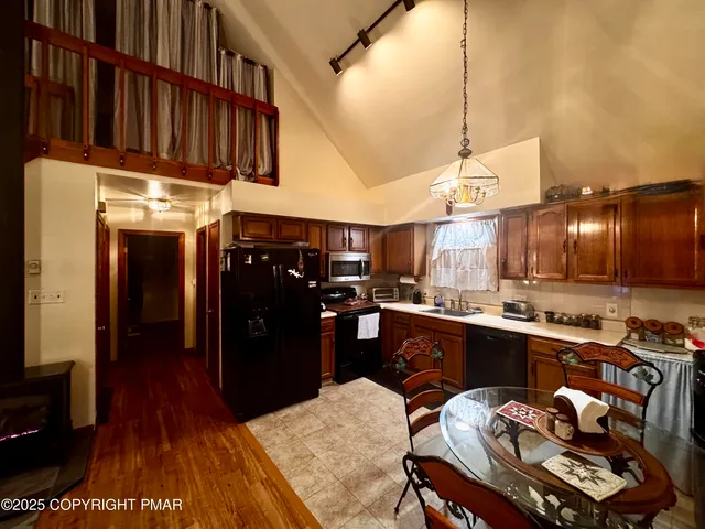 a kitchen with a sink appliances and cabinets