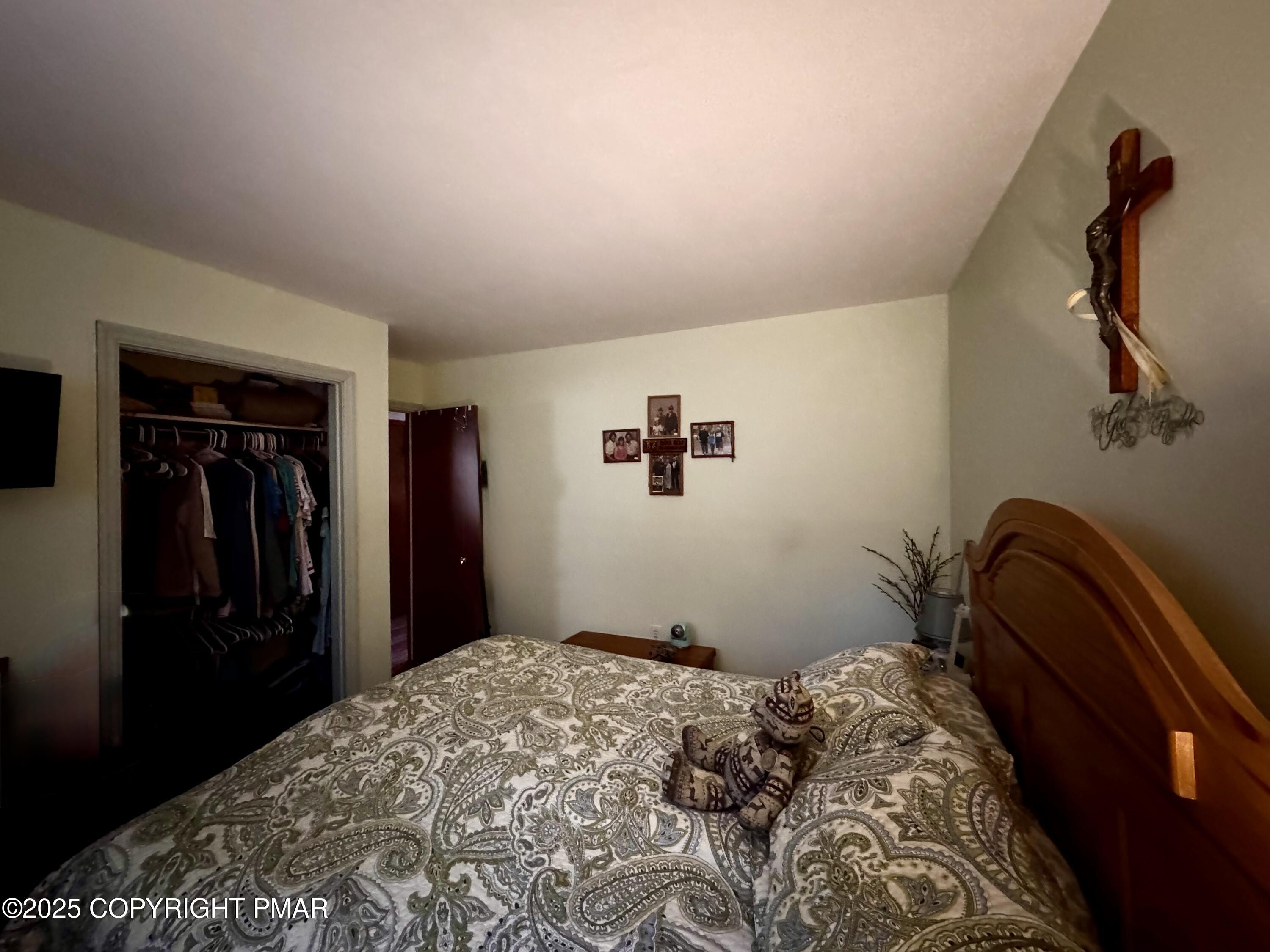 102 Indian Trail Road Jim Thorpe, PA 18229 - Photo 7 of 28 a bedroom with a bed and a painting on the wall