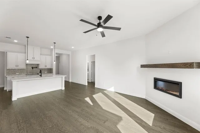 a view of kitchen with sink microwave and stove