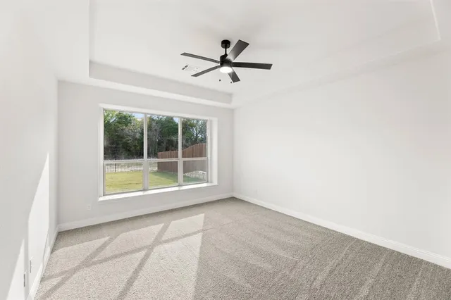a view of empty room with ceiling fan