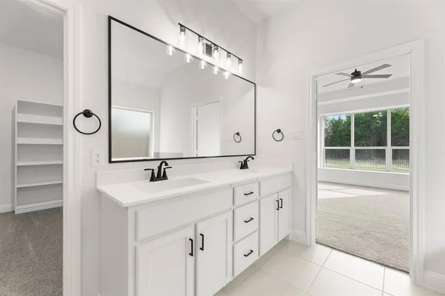a bathroom with a double vanity sink mirror and double