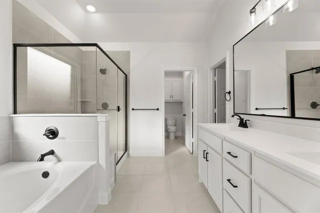 a spacious bathroom with a tub sink and mirror
