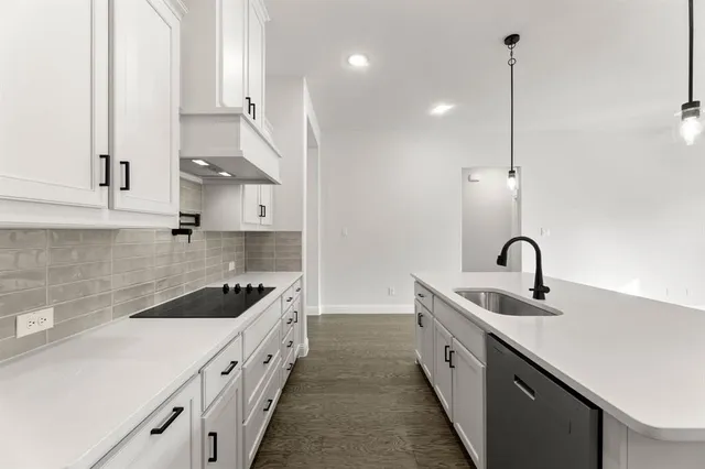a kitchen with a sink and cabinets