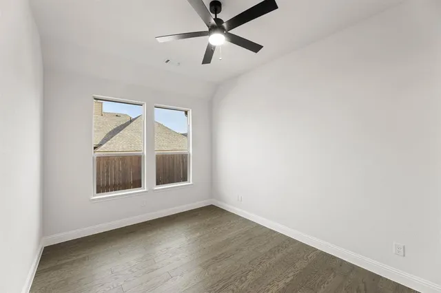 an empty room with cabinet and a window