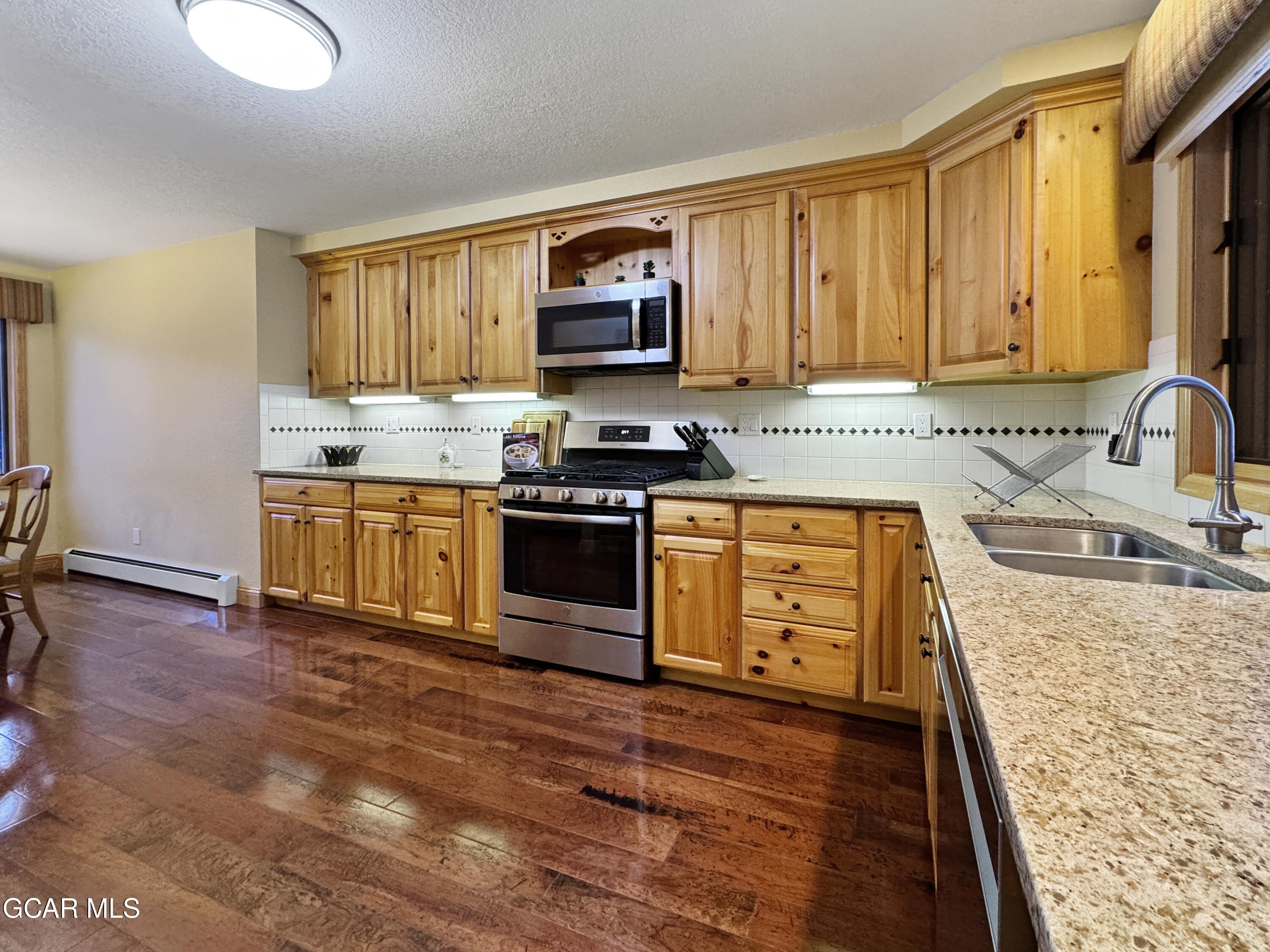 1232 Gcr 8 Tabernash, CO 80478 - Photo 13 of 51 a kitchen with stainless steel appliances granite countertop a stove sink and cabinets