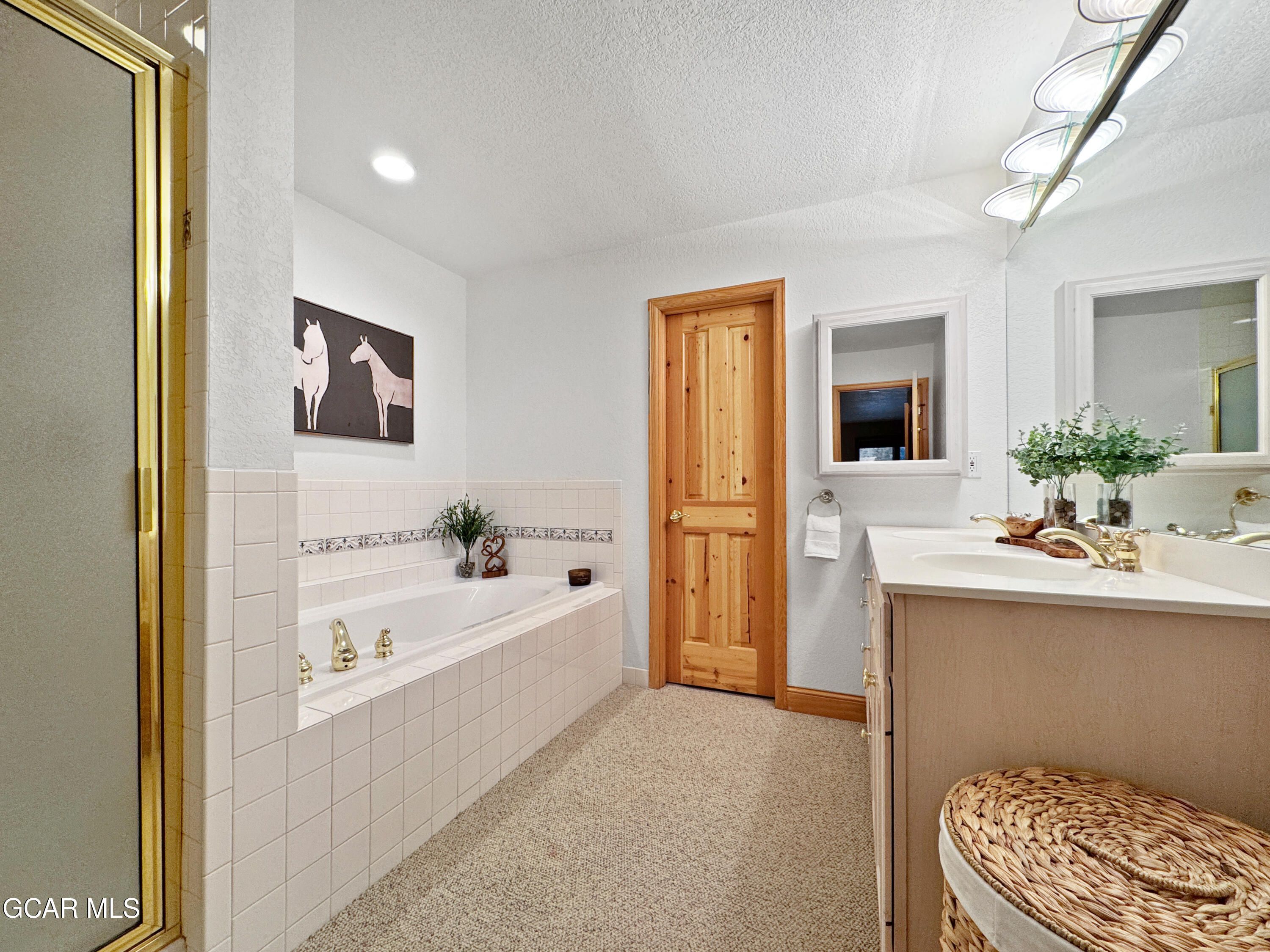 1232 Gcr 8 Tabernash, CO 80478 - Photo 23 of 51 a bathroom with a bathtub sink and mirror