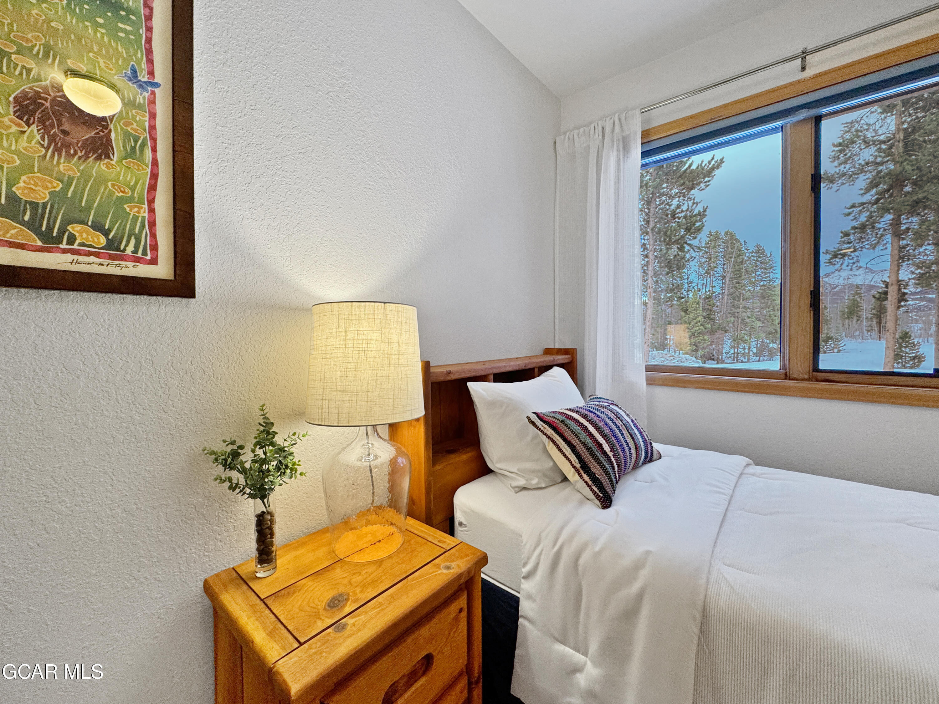 1232 Gcr 8 Tabernash, CO 80478 - Photo 34 of 51 a bedroom with a bed and wooden floor