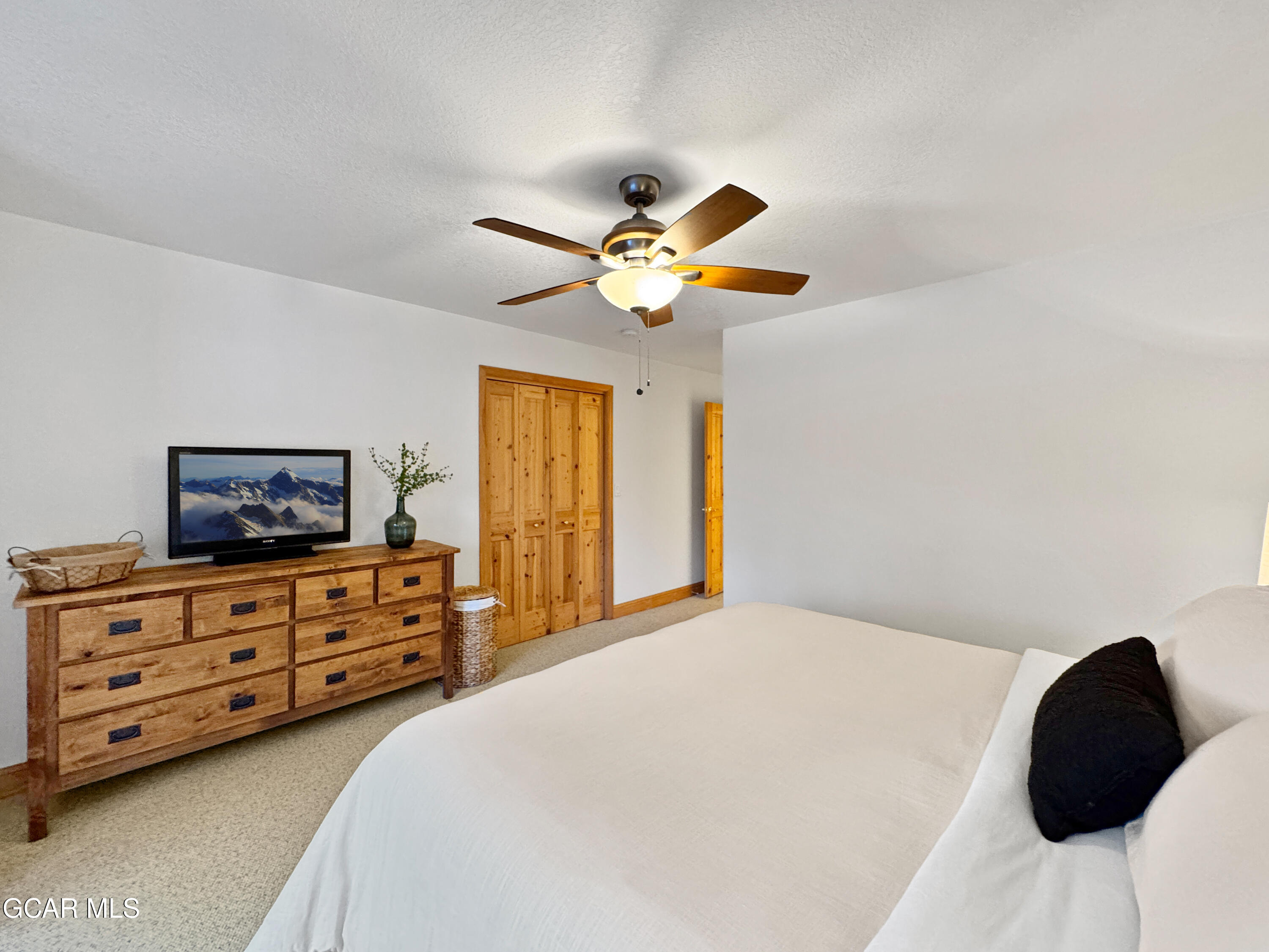 1232 Gcr 8 Tabernash, CO 80478 - Photo 41 of 51 a bedroom with a bed a chandelier and a closet