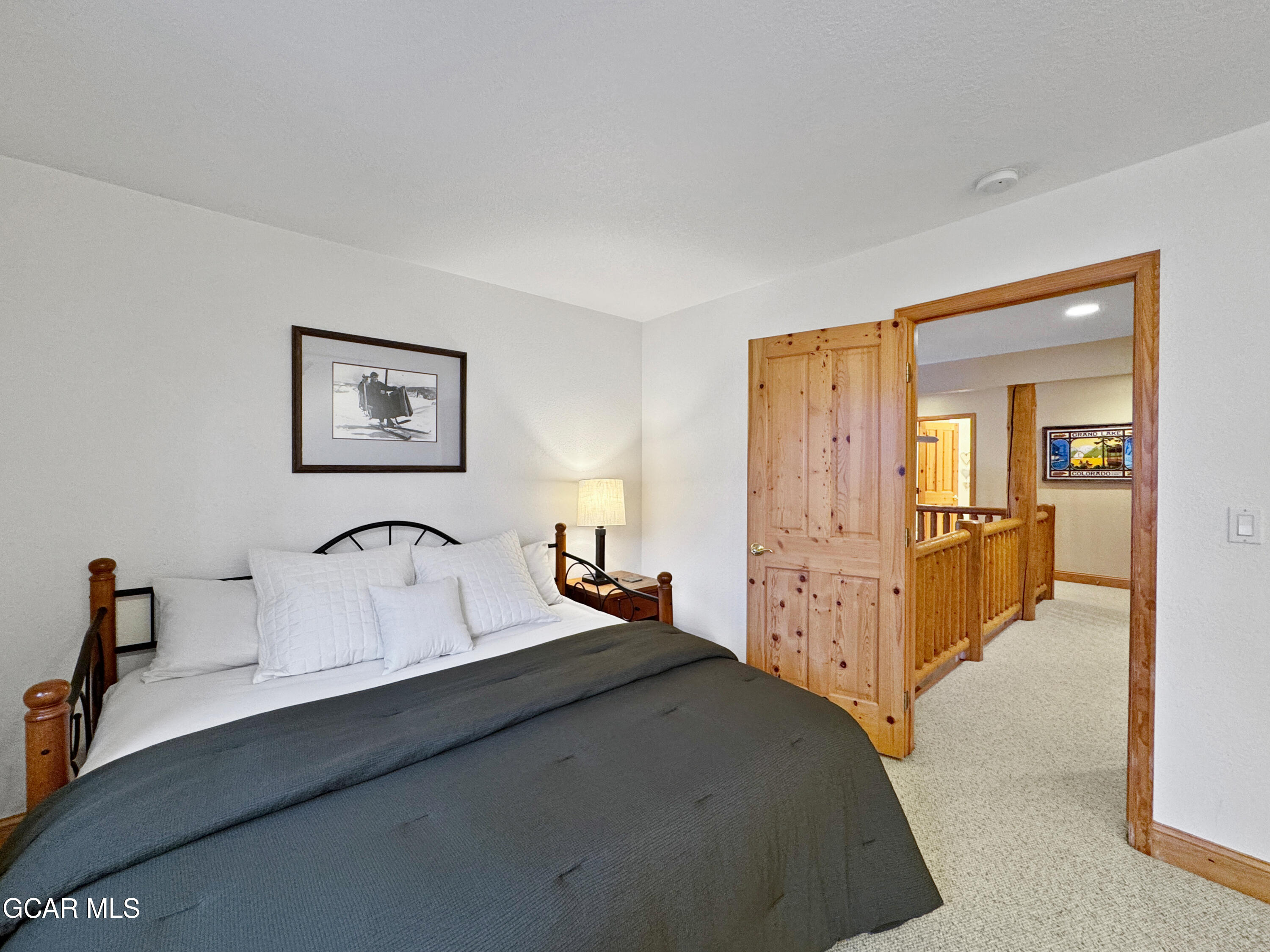 1232 Gcr 8 Tabernash, CO 80478 - Photo 47 of 51 a bedroom with a bed and a lamp on dresser