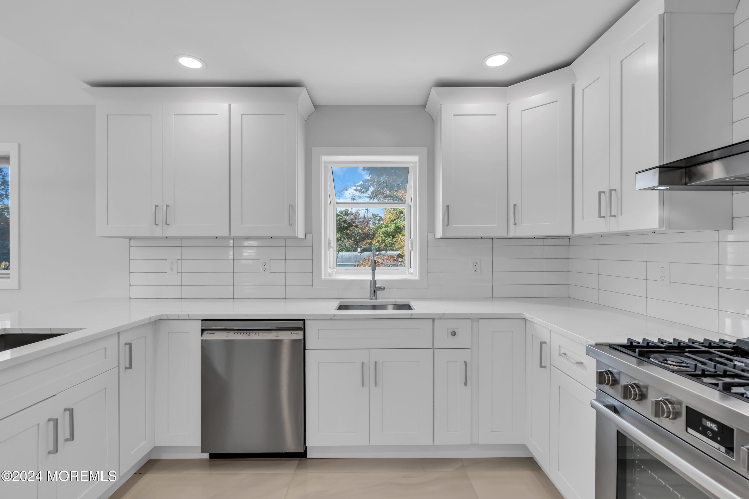 44 Lexington Road Howell, NJ 07731 - Photo 13 of 45 a kitchen with white cabinets appliances and a sink