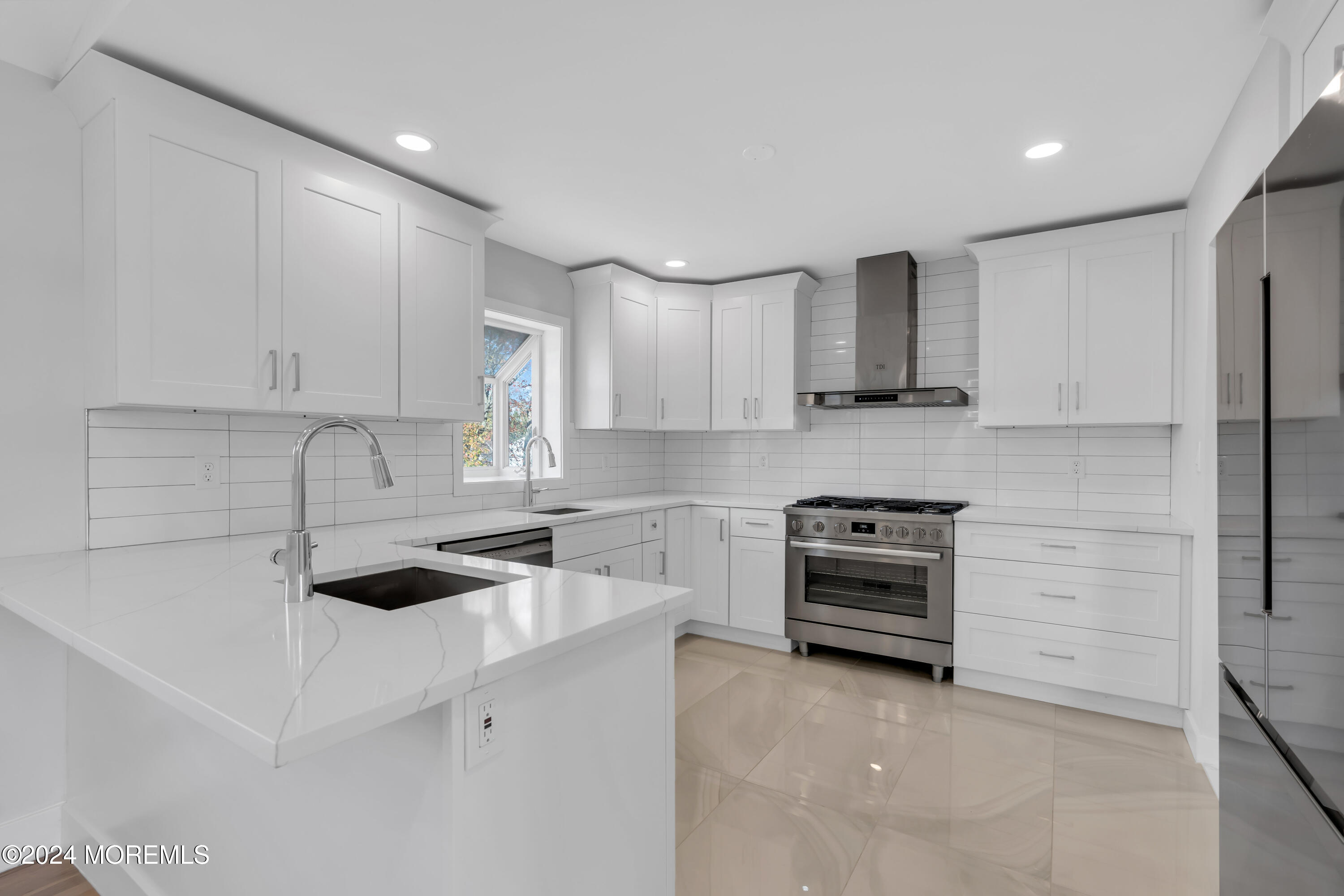 44 Lexington Road Howell, NJ 07731 - Photo 16 of 45 a kitchen with white cabinets and stainless steel appliances
